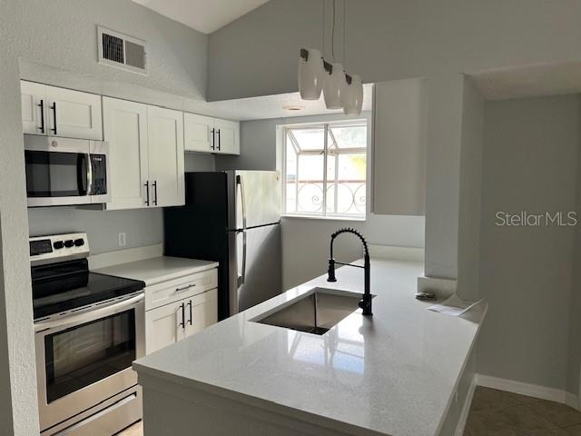 5128 Conroy Road, Unit 22 Orlando, FL 32811 - Photo 5 of 9 a kitchen with granite countertop a stove a refrigerator and a sink