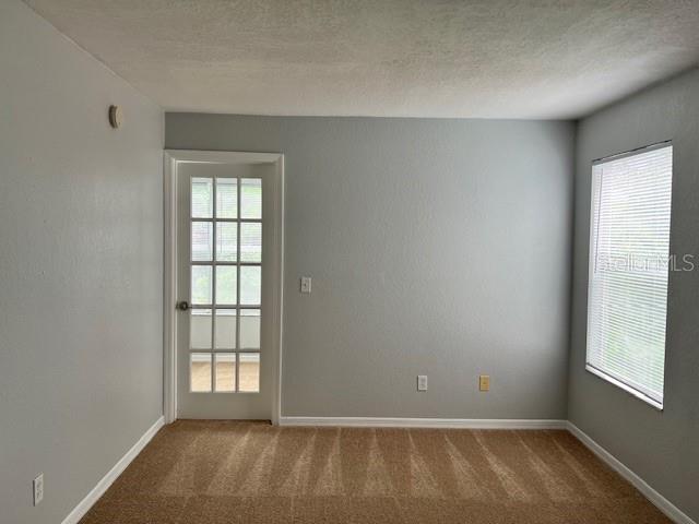 5128 Conroy Road, Unit 22 Orlando, FL 32811 - Photo 8 of 9 an empty room with windows