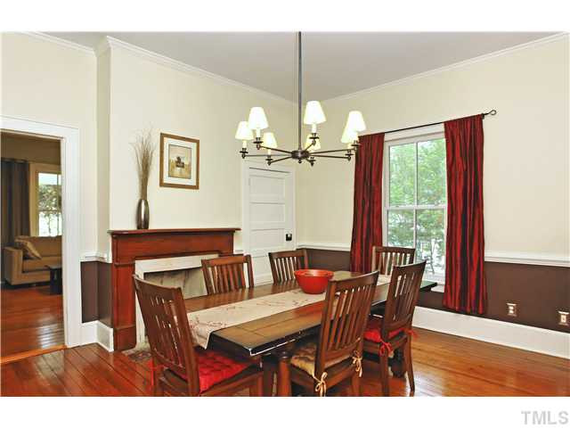2306 Bedford Avenue Raleigh, NC 27607 - Photo 5 of 17 BIG dining room has a dramatic look with updated lighting and a decorative fireplace. Dining Room