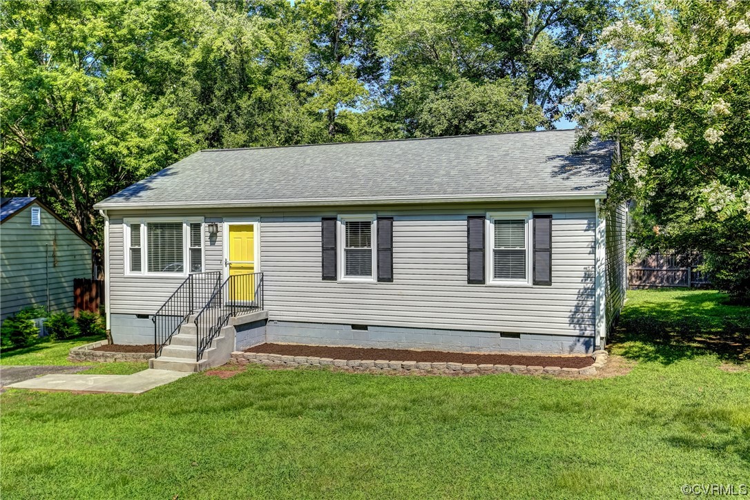 a front view of house with yard and green space