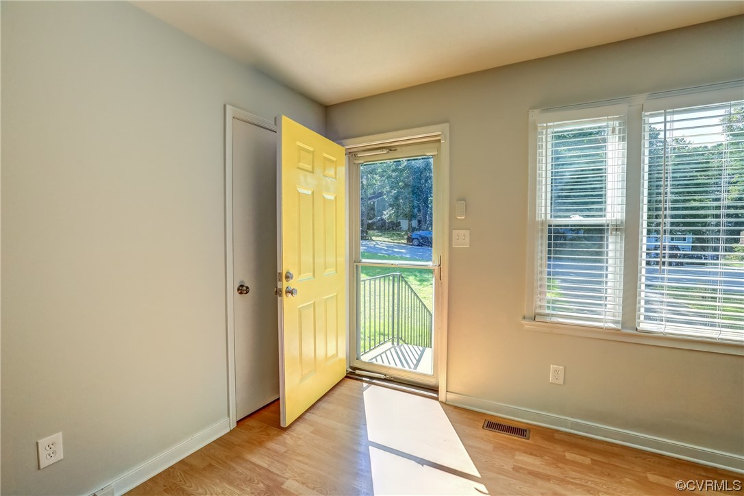 1522 Rayburn Road Richmond, VA 23235 - Photo 11 of 38 a view of an empty room with wooden floor and a window