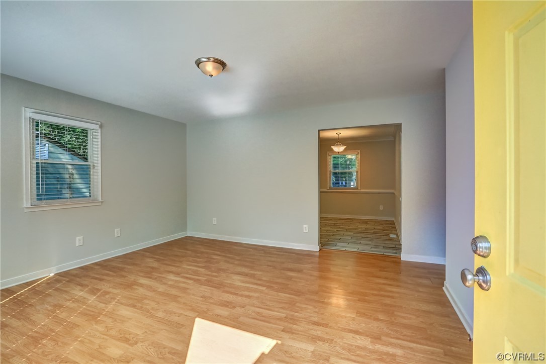 1522 Rayburn Road Richmond, VA 23235 - Photo 12 of 38 a view of an empty room with wooden floor and a window