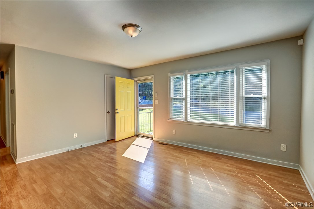 1522 Rayburn Road Richmond, VA 23235 - Photo 14 of 38 an empty room with wooden floor and windows