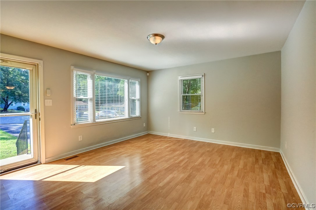 1522 Rayburn Road Richmond, VA 23235 - Photo 15 of 38 an empty room with wooden floor and windows