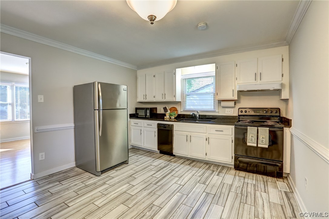 1522 Rayburn Road Richmond, VA 23235 - Photo 17 of 38 a kitchen with a refrigerator and white cabinets