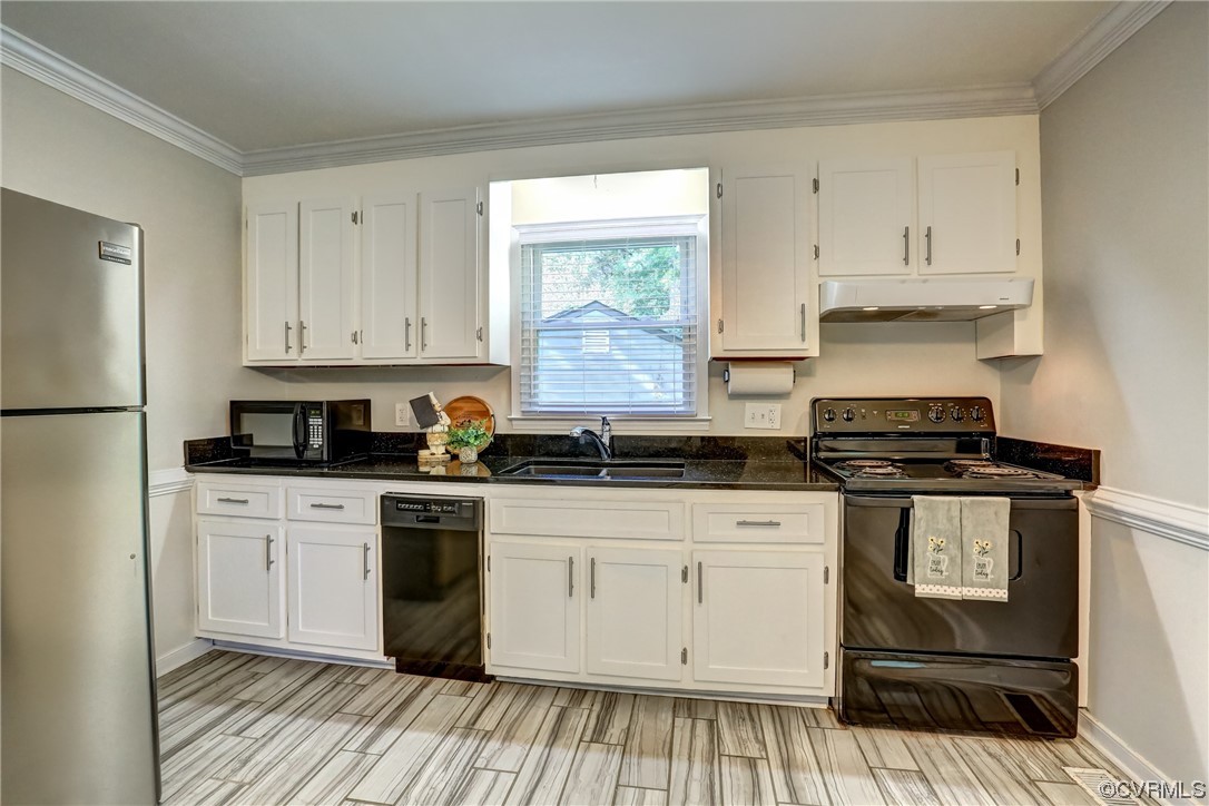 1522 Rayburn Road Richmond, VA 23235 - Photo 18 of 38 a kitchen with a stove and white cabinets