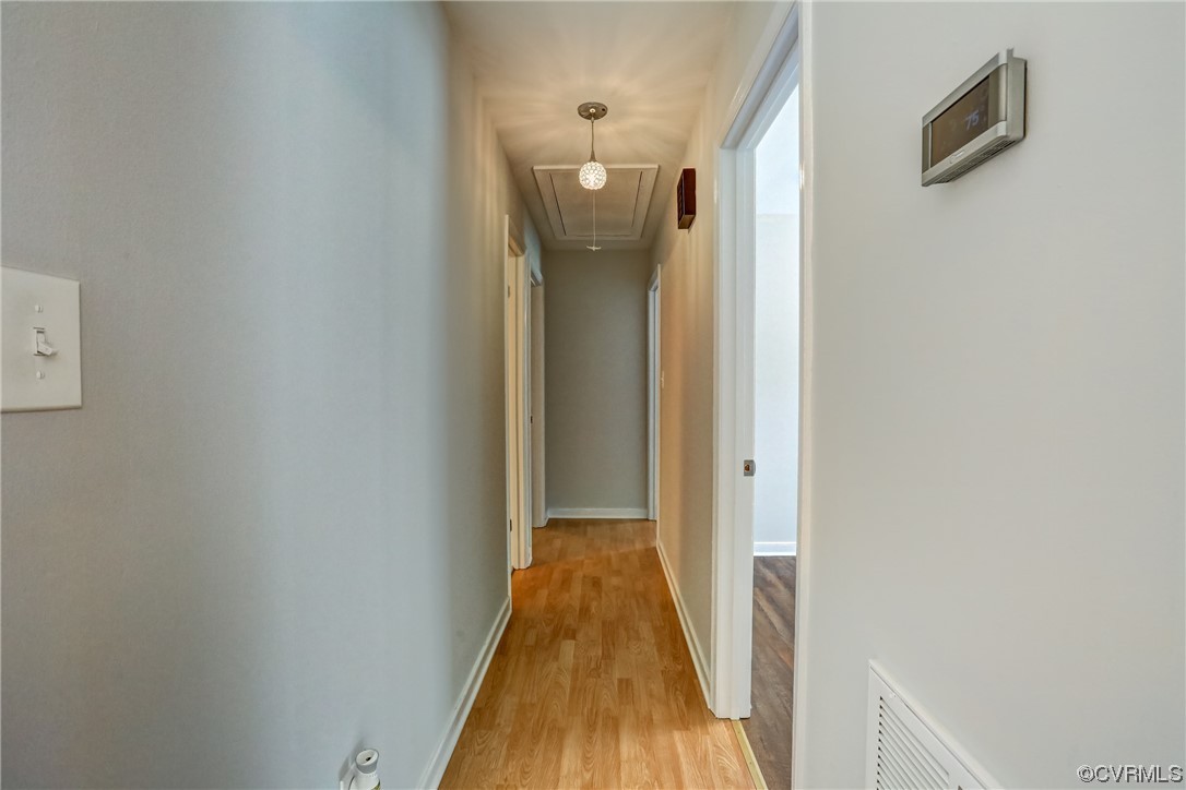 1522 Rayburn Road Richmond, VA 23235 - Photo 23 of 38 a view of a hallway with wooden floor and a bathroom