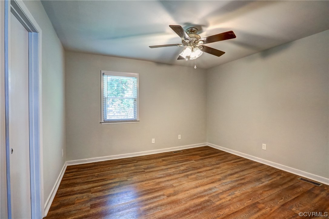 1522 Rayburn Road Richmond, VA 23235 - Photo 28 of 38 an empty room with wooden floor fan and windows