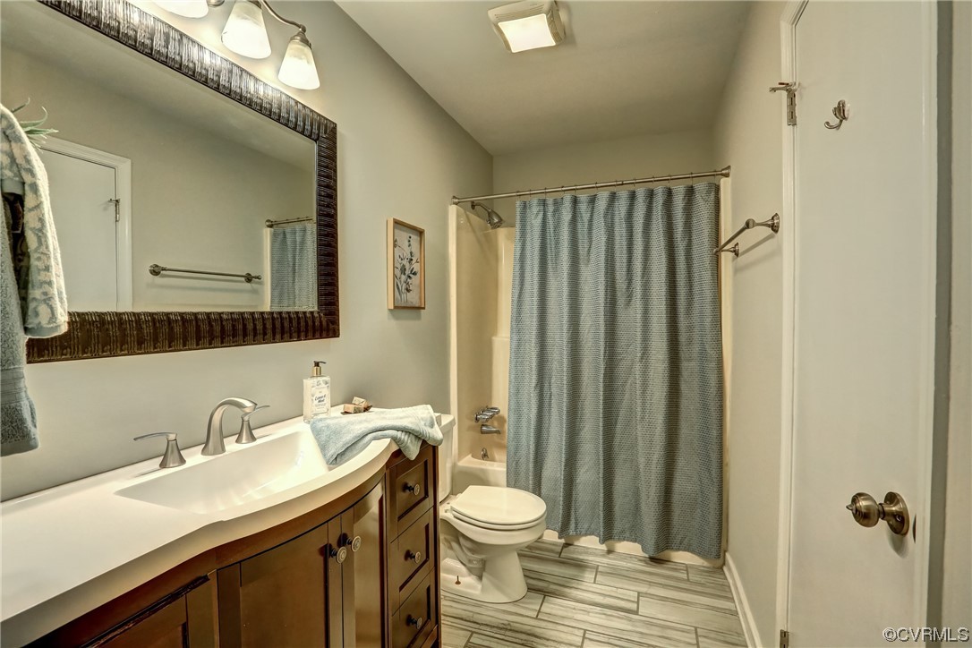 1522 Rayburn Road Richmond, VA 23235 - Photo 31 of 38 a bathroom with a granite countertop sink toilet a mirror and shower