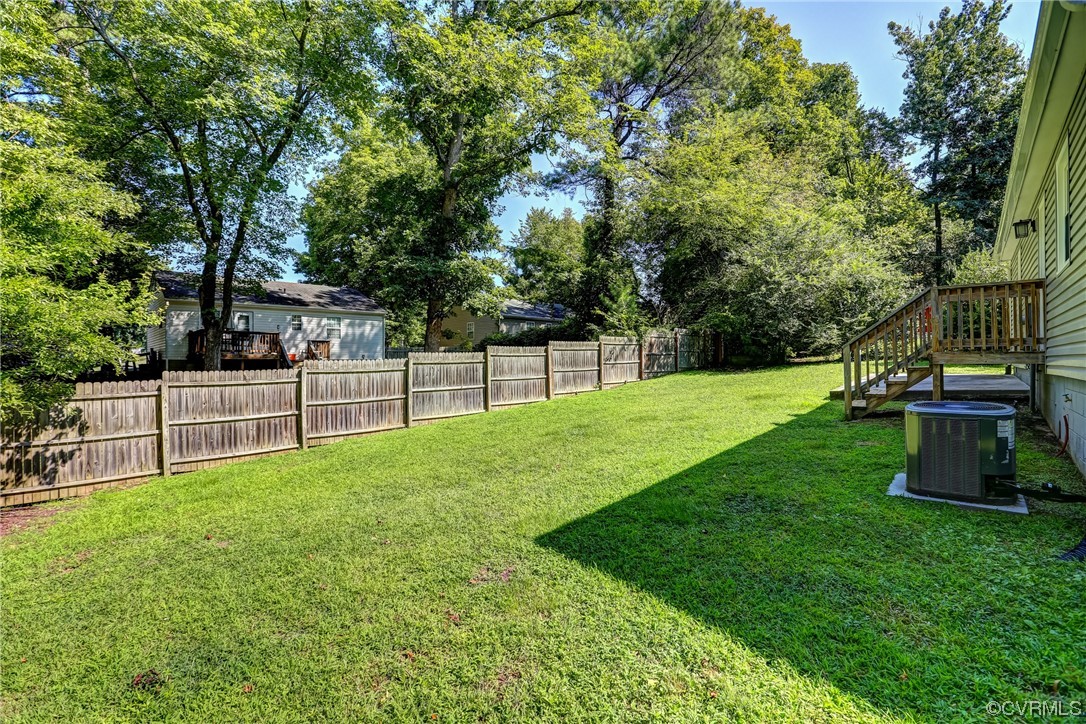 1522 Rayburn Road Richmond, VA 23235 - Photo 32 of 38 a view of a backyard with wooden fence and a bench