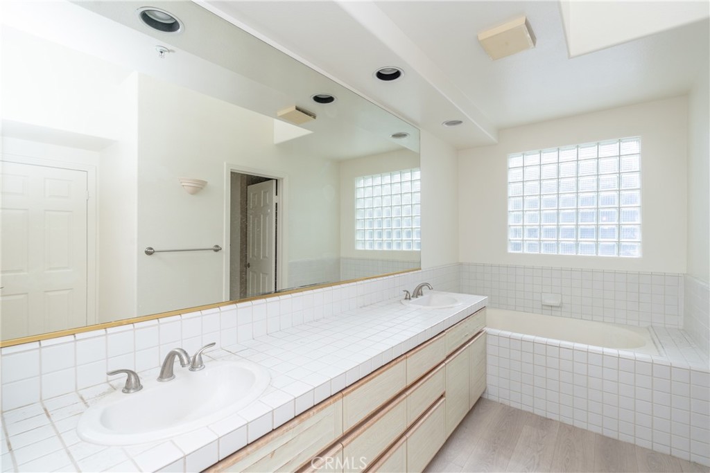 2253 Martin, Unit 416 Irvine, CA 92612 - Photo 16 of 23 a spacious bathroom with a tub sink and mirror