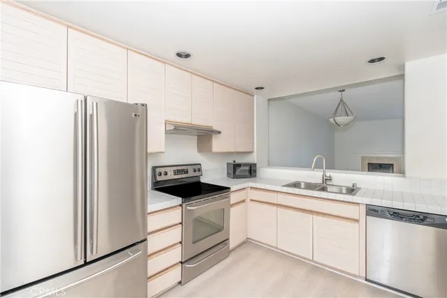 a kitchen with white cabinets and white appliances