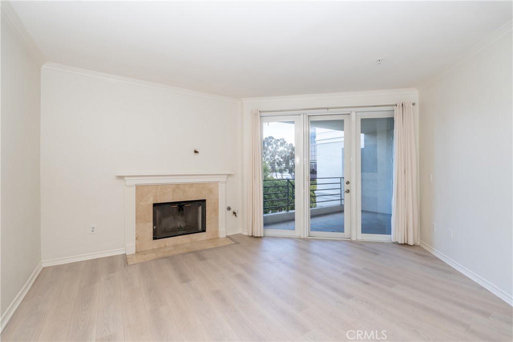 2253 Martin, Unit 416 Irvine, CA 92612 - Photo 8 of 23 an empty room with wooden floor fireplace and windows
