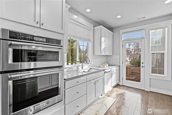 a kitchen with a stove oven and sink