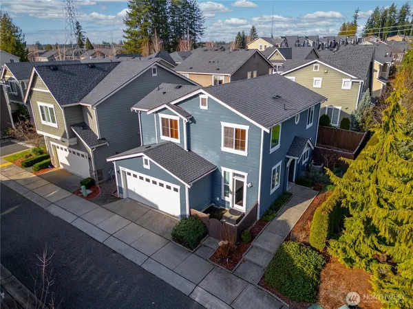 an aerial view of a house with a yard