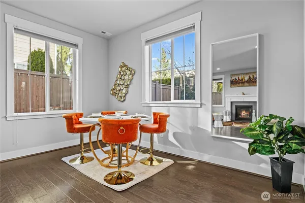 a living room with furniture a potted plant and a fireplace