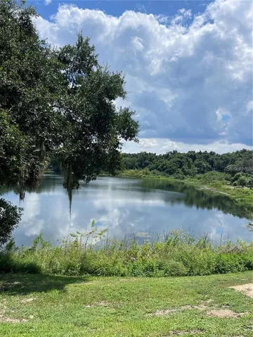 a view of a lake with a house in the background