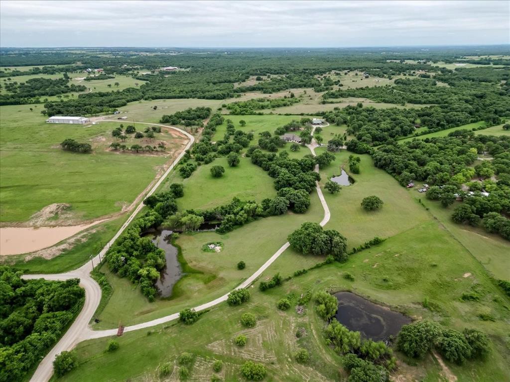 318 East Lone Star Road Poolville, TX 76487 - Photo 5 of 33 an aerial view of a residential houses with outdoor space and trees all around
