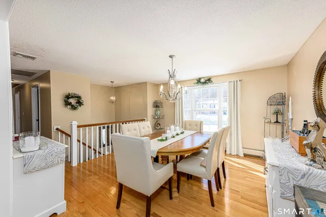 a living room with furniture a couch and wooden floor