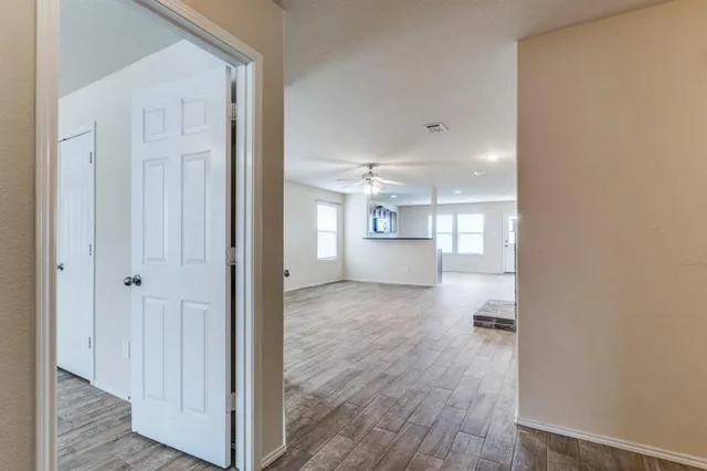 a view of kitchen and hall with wooden floor