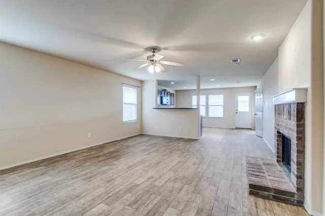 a view of a kitchen with wooden floor and a kitchen space