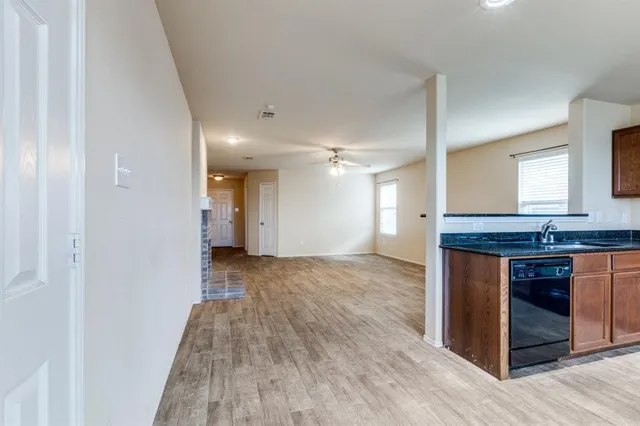 a view of kitchen with granite countertop cabinets and wooden floor