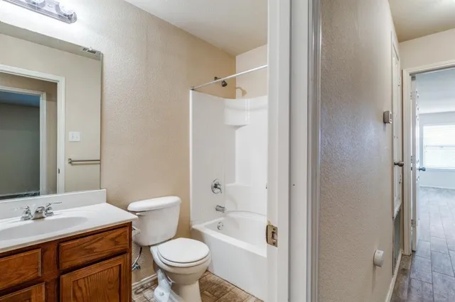 a bathroom with a sink toilet vanity and shower