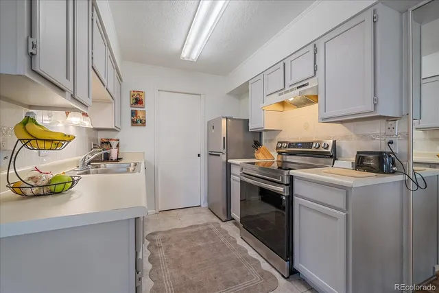 a kitchen with a sink stove and cabinets