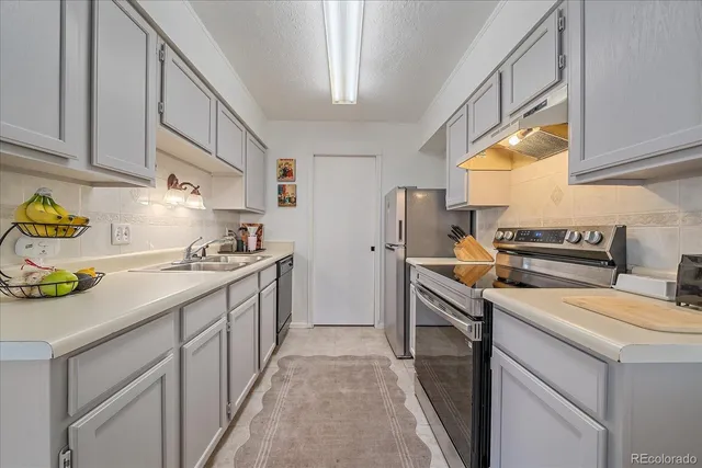 a kitchen filled with a sink cabinets and appliances