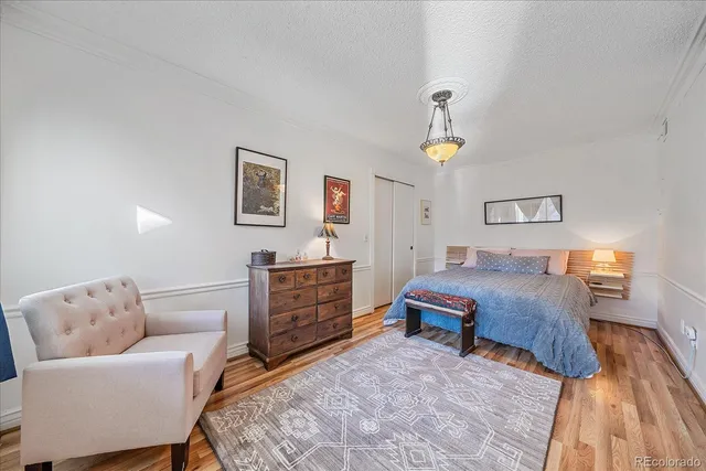 a bed room with a bed and a chandelier