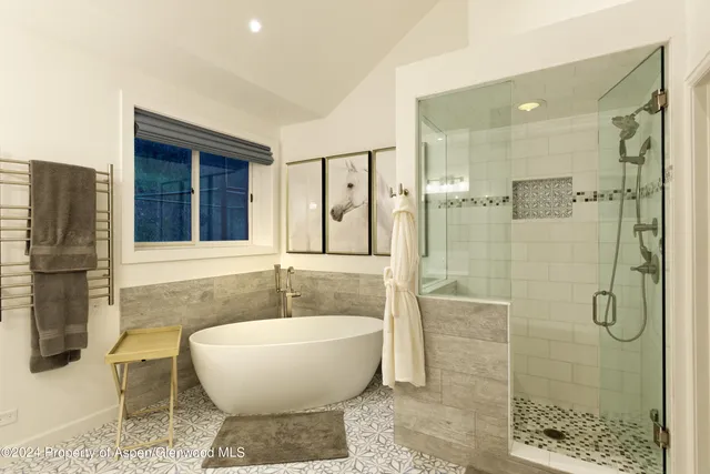a spacious bathroom with a bathtub and shower