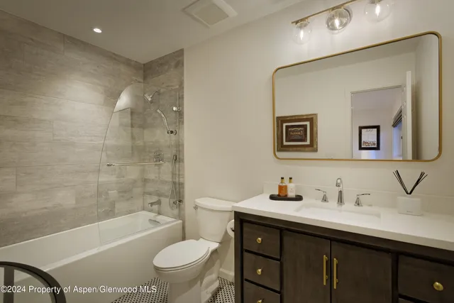 a bathroom with a sink a toilet and a bathtub