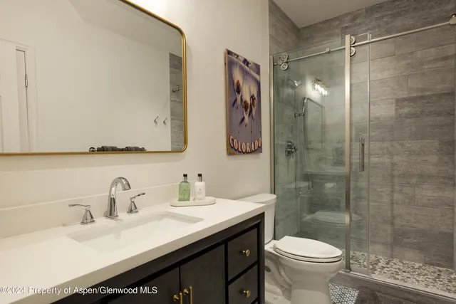 a bathroom with a sink toilet and shower