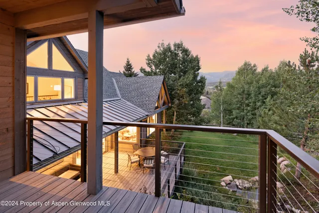 a view of balcony with wooden floor and fence
