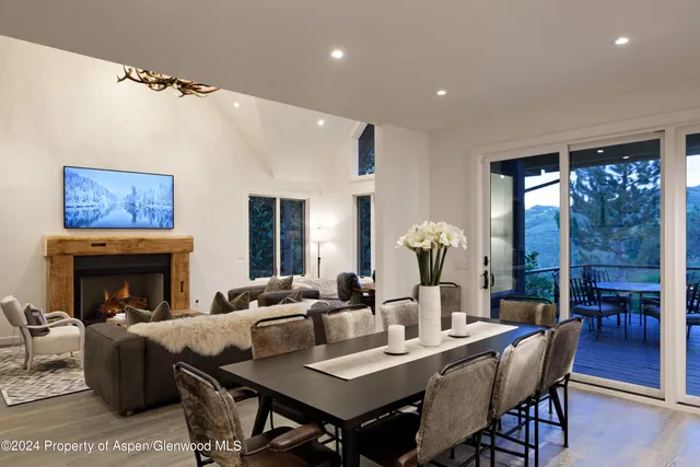 a living room with furniture a table and a fireplace