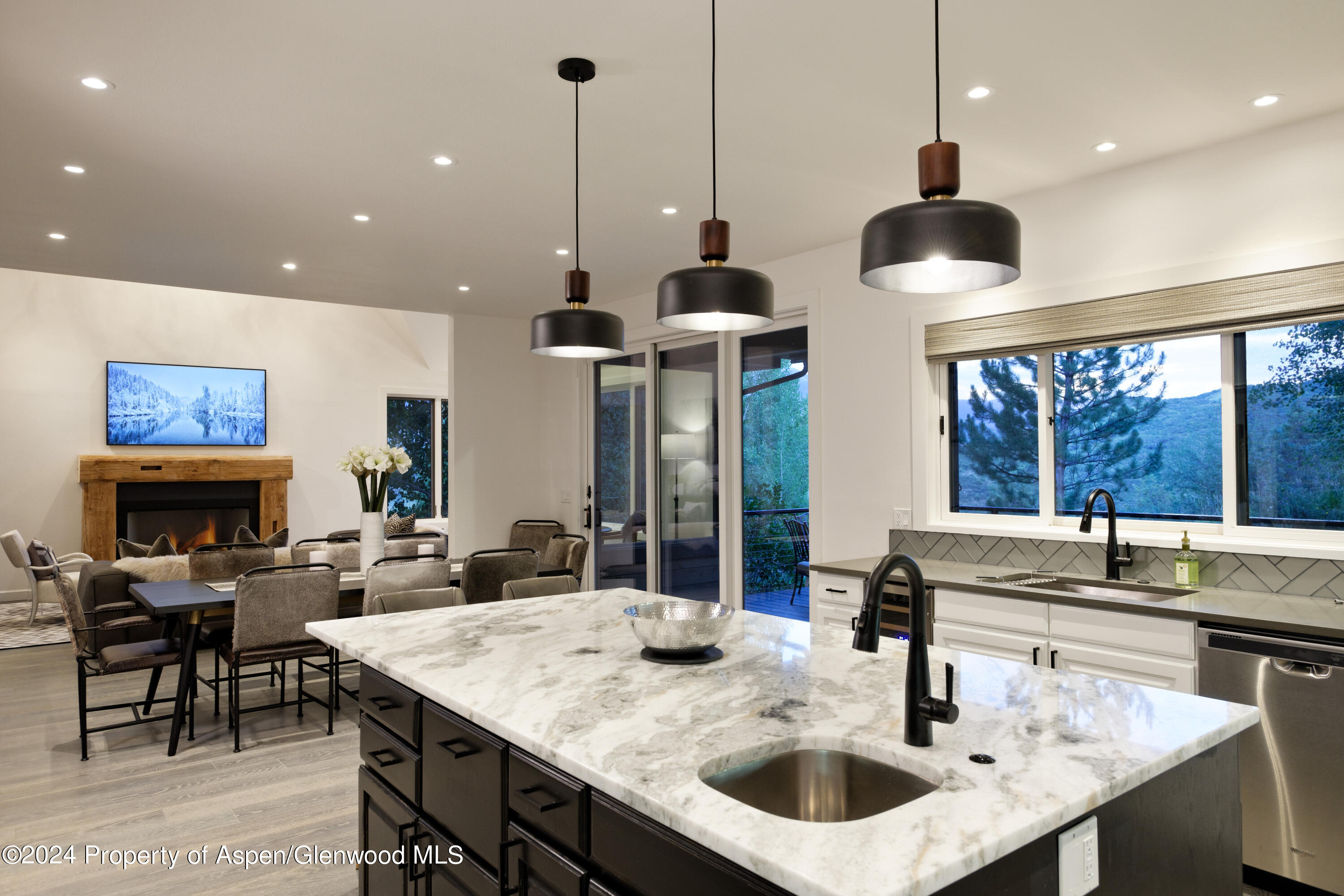 400 Medicine Bow Road Aspen, CO 81611 - Photo 8 of 36 a kitchen with a counter a sink and living room view