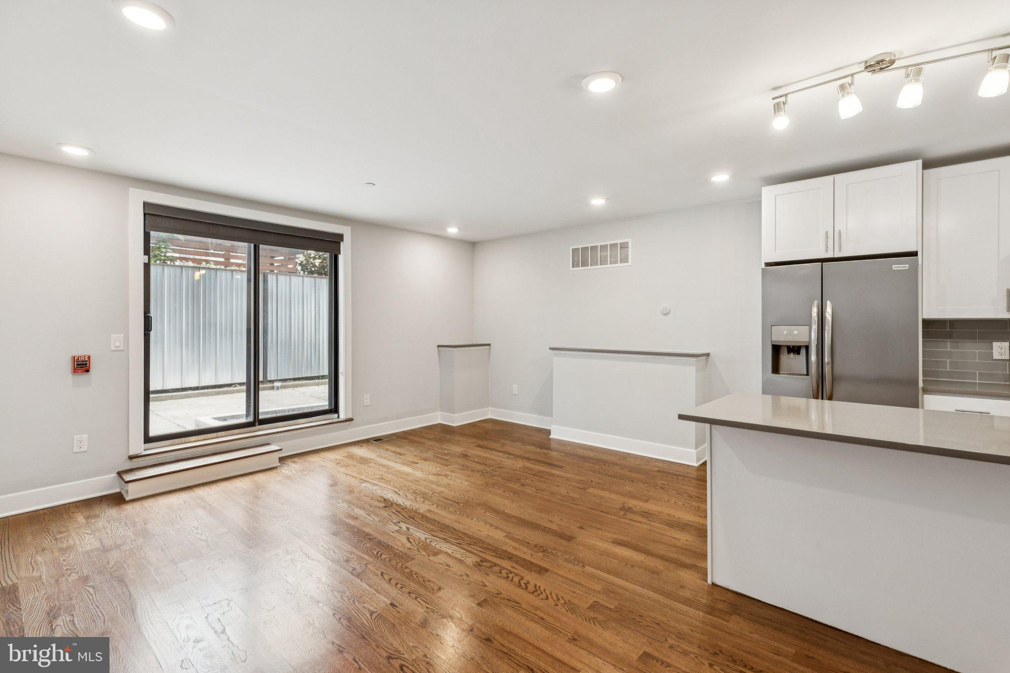 814 North Uber Street, Unit 2 Philadelphia, PA 19130 - Photo 13 of 68 a view of an empty room with a window and wooden floor