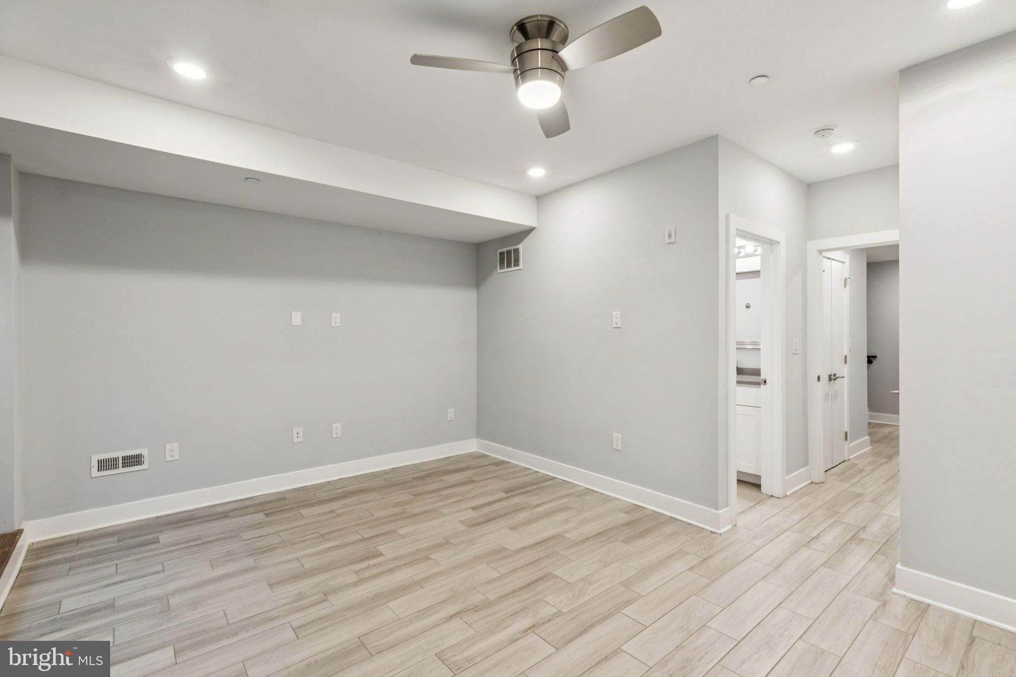 814 North Uber Street, Unit 2 Philadelphia, PA 19130 - Photo 21 of 68 an empty room with wooden floor and a ceiling fan
