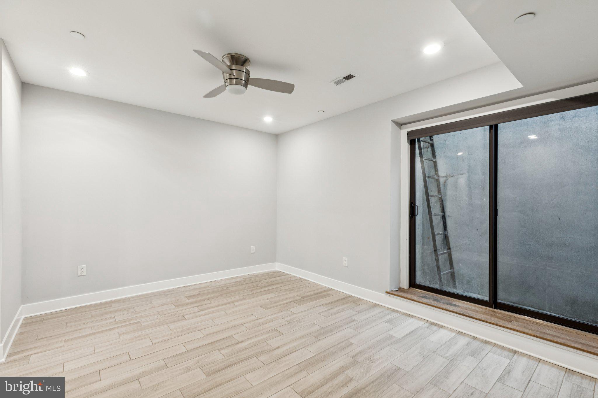 814 North Uber Street, Unit 2 Philadelphia, PA 19130 - Photo 24 of 68 an empty room with wooden floor and door