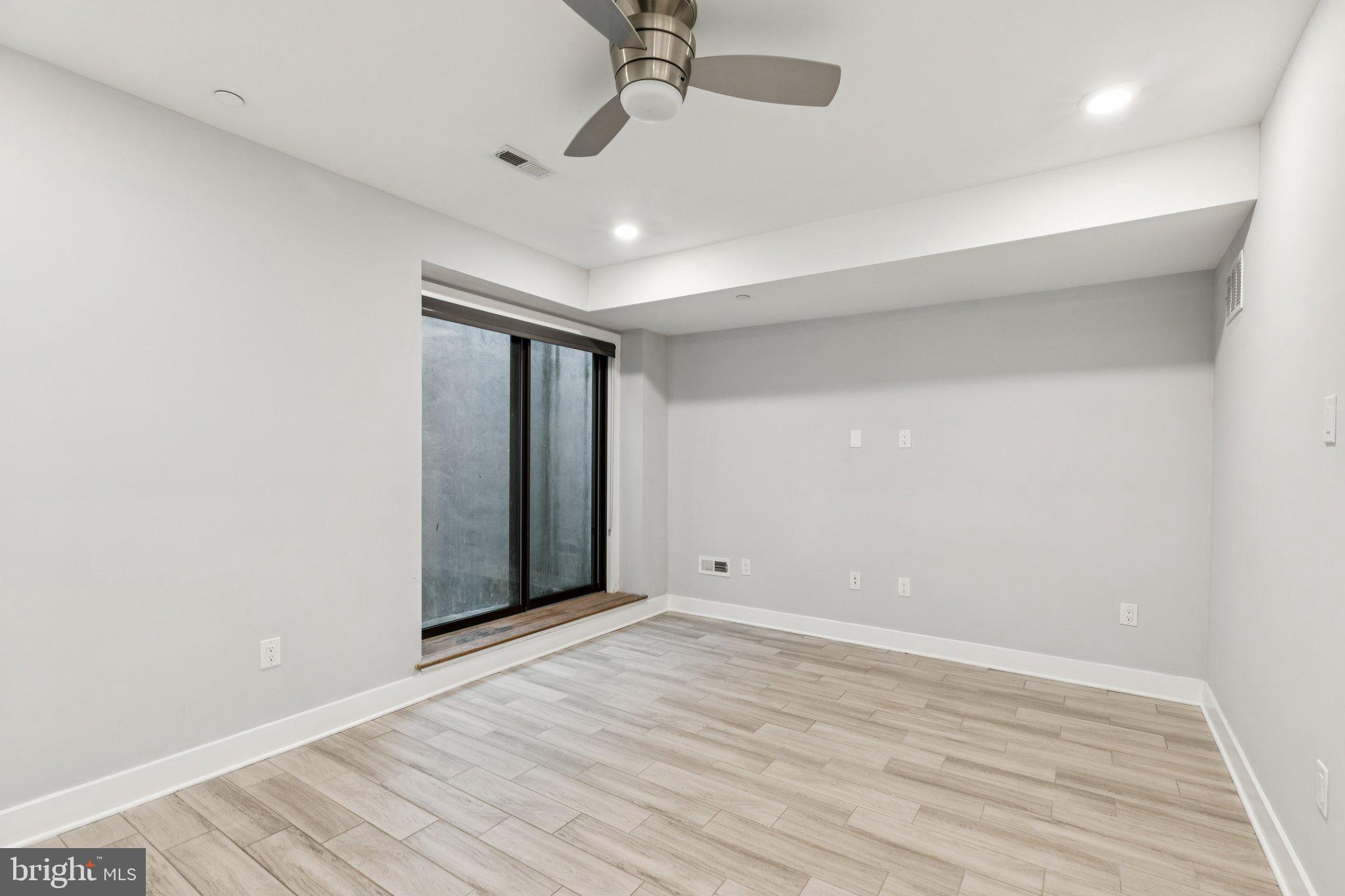 814 North Uber Street, Unit 2 Philadelphia, PA 19130 - Photo 27 of 68 wooden floor in an empty room with a window