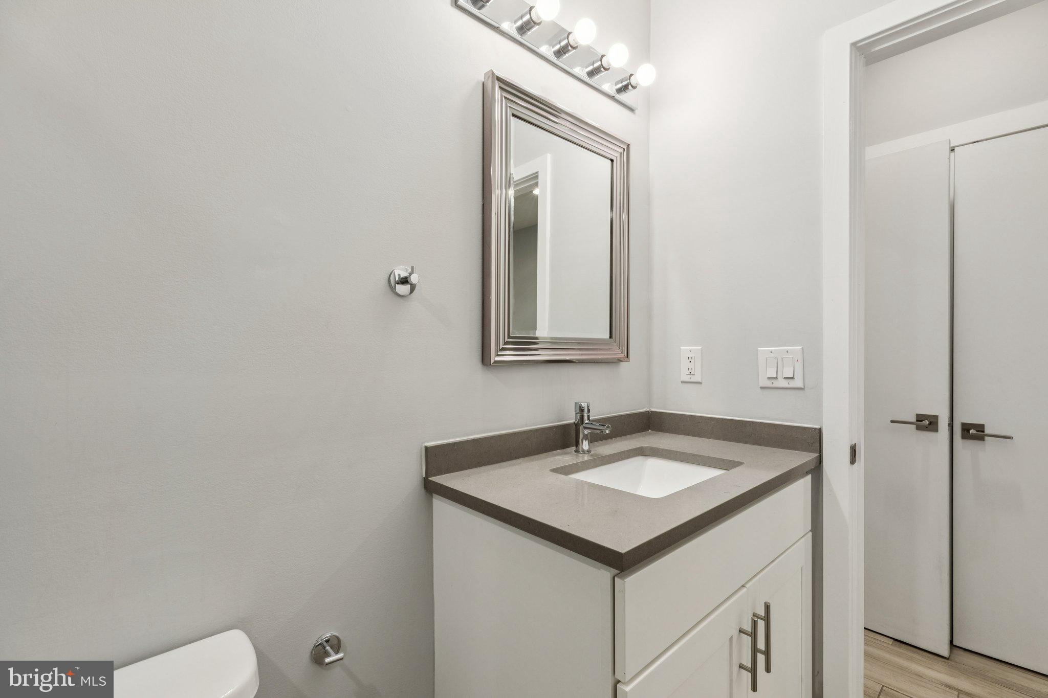 814 North Uber Street, Unit 2 Philadelphia, PA 19130 - Photo 29 of 68 a bathroom with a sink and a mirror