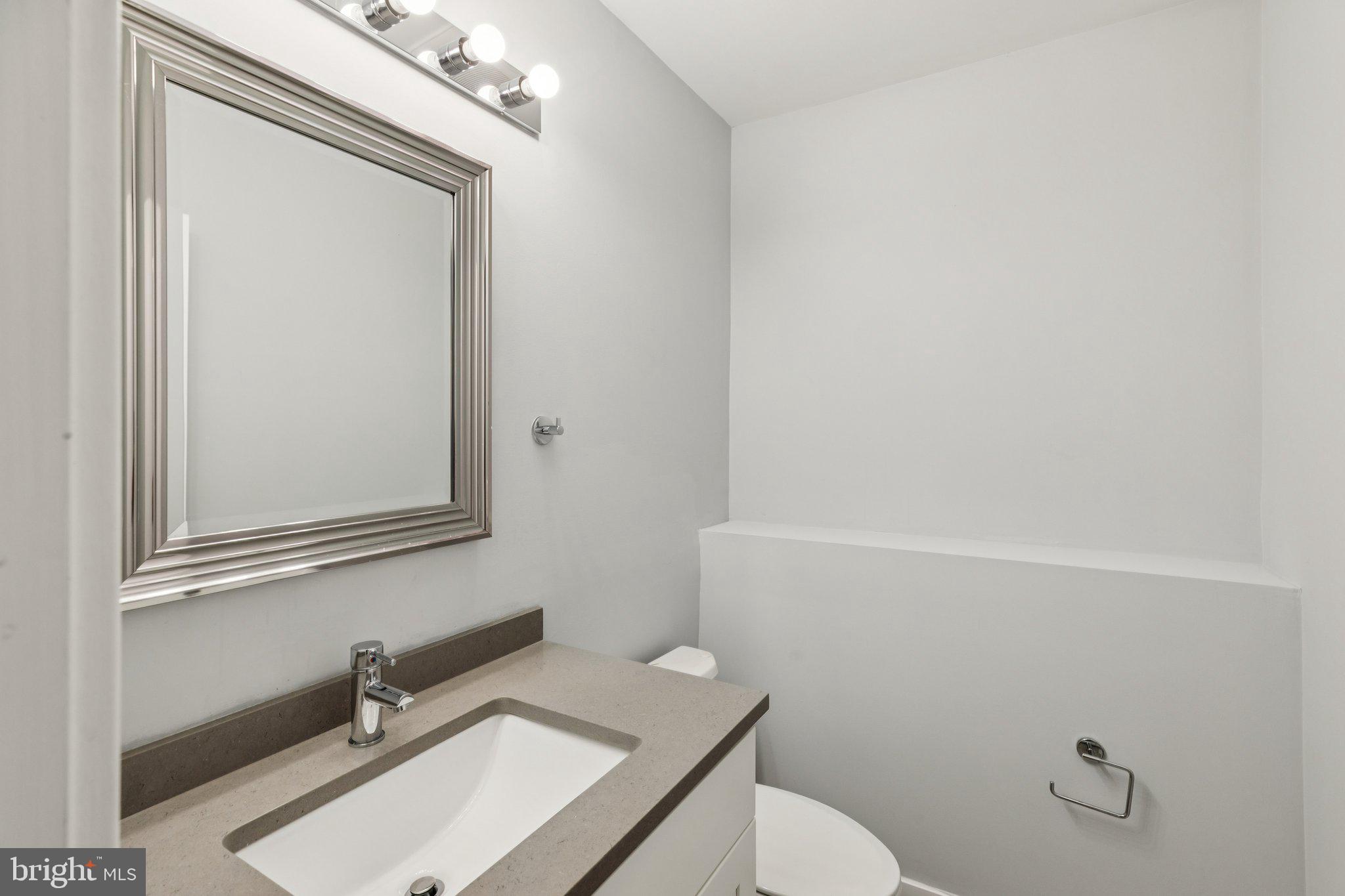 814 North Uber Street, Unit 2 Philadelphia, PA 19130 - Photo 49 of 68 a bathroom with a sink a toilet and mirror