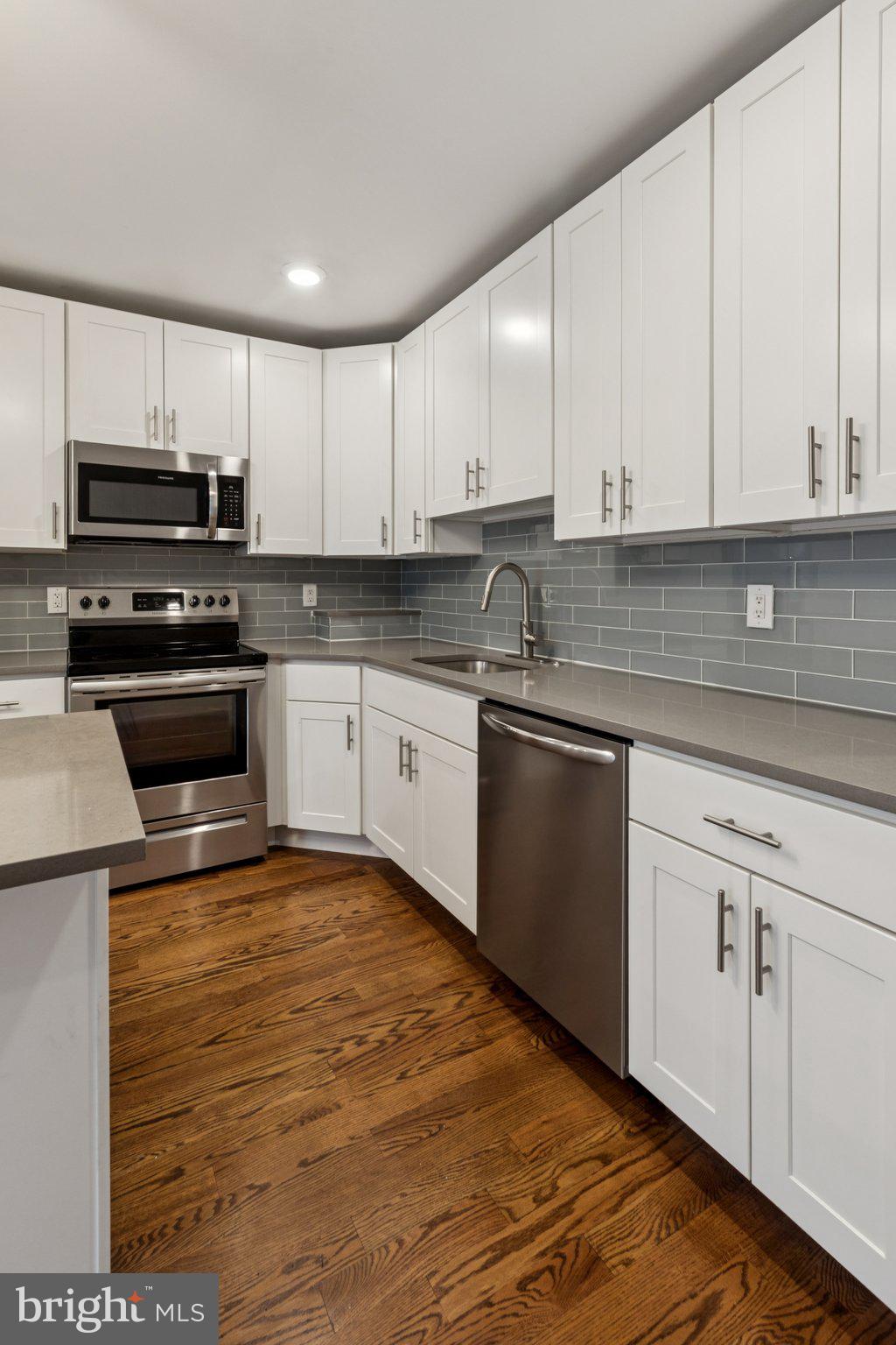 814 North Uber Street, Unit 2 Philadelphia, PA 19130 - Photo 5 of 68 a kitchen with stainless steel appliances granite countertop a sink and cabinets