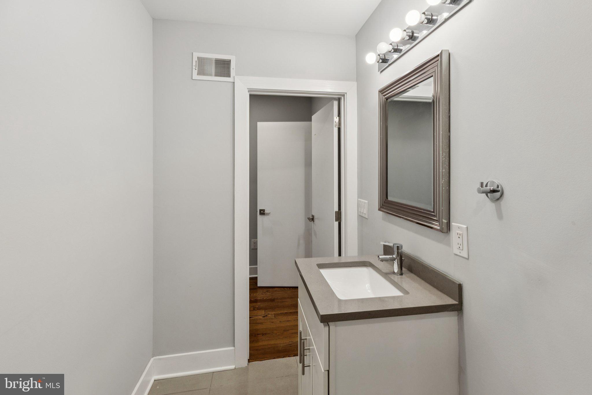 814 North Uber Street, Unit 2 Philadelphia, PA 19130 - Photo 51 of 68 a bathroom with a sink and a mirror