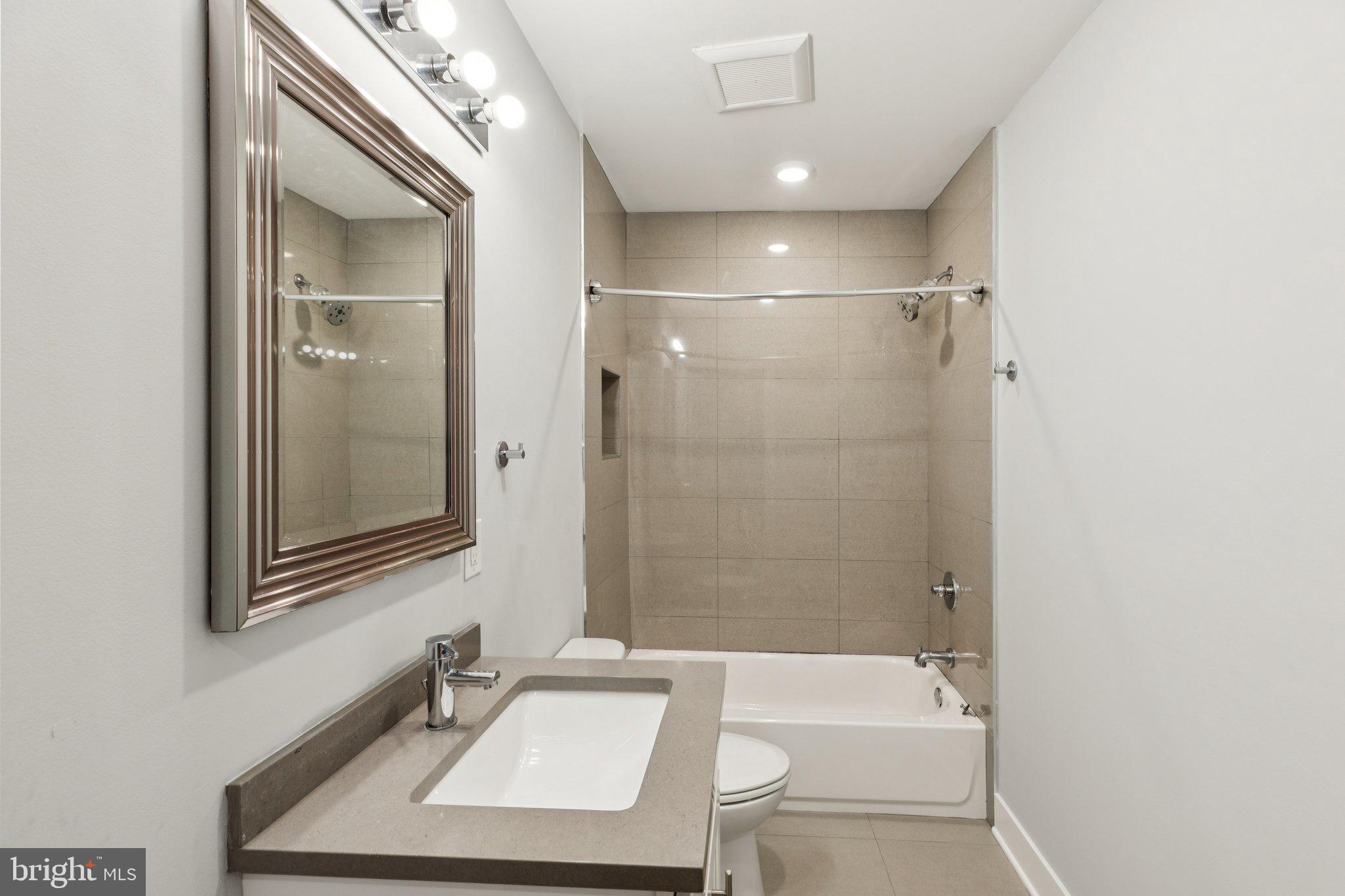 814 North Uber Street, Unit 2 Philadelphia, PA 19130 - Photo 54 of 68 a bathroom with a sink a toilet a mirror and shower