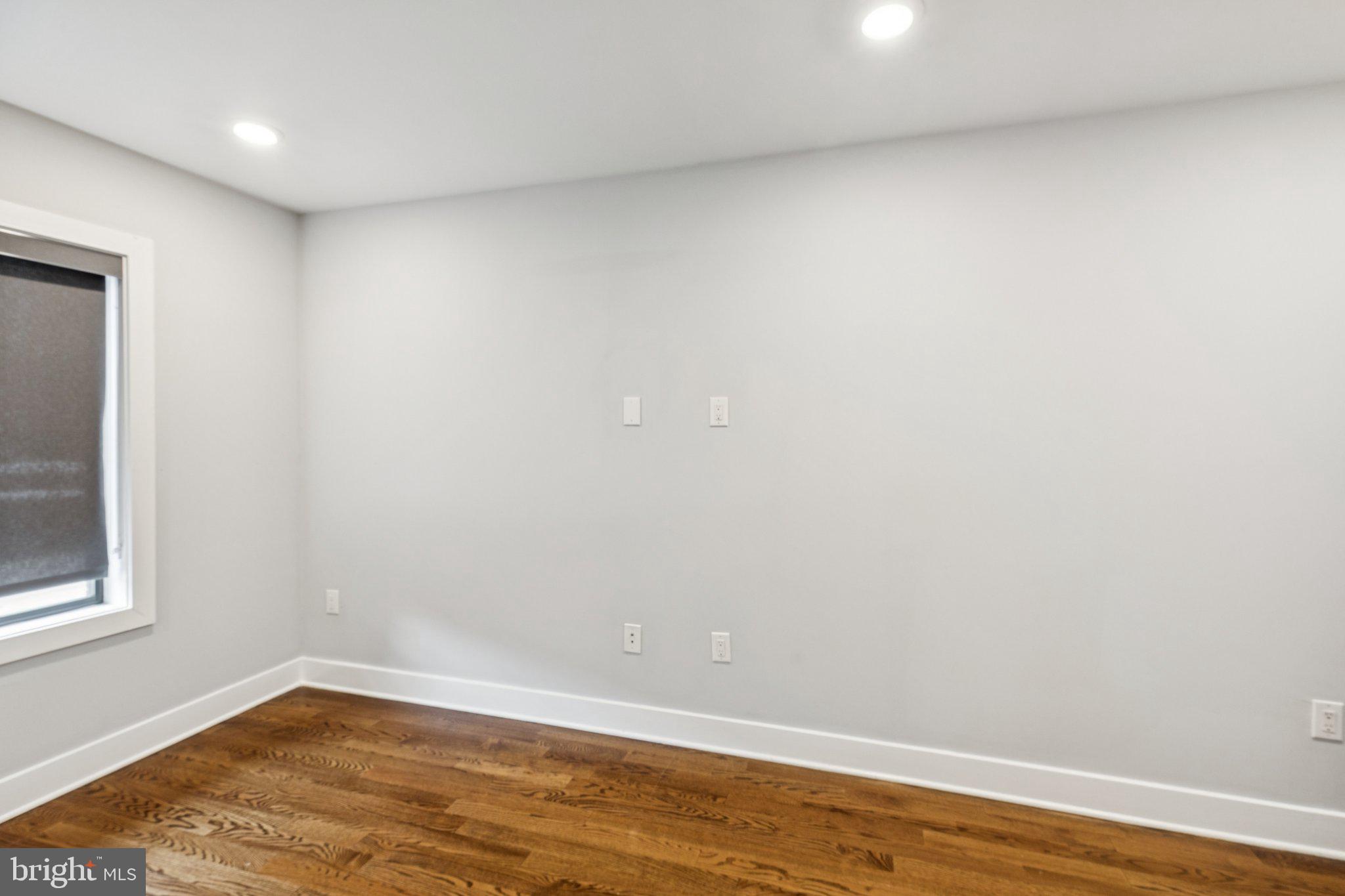 814 North Uber Street, Unit 2 Philadelphia, PA 19130 - Photo 56 of 68 a view of an empty room with wooden floor and a window