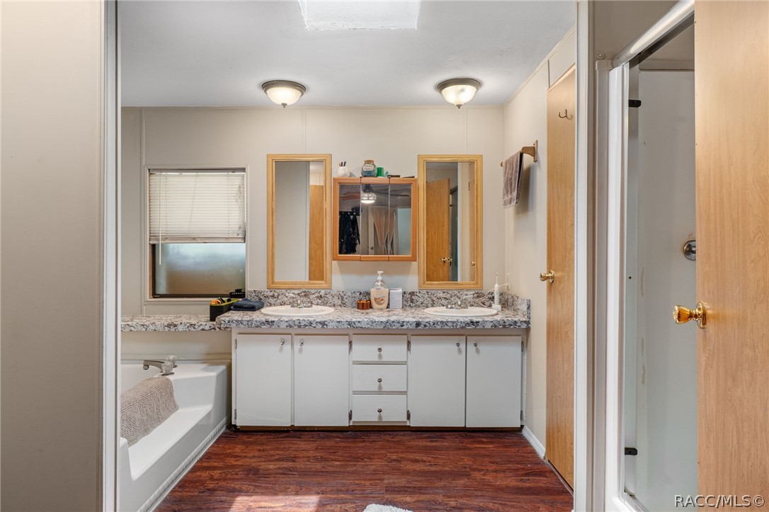7927 West Cyprian Court Homosassa, FL 34448 - Photo 23 of 40 a bathroom with a granite countertop sink vanity and mirror