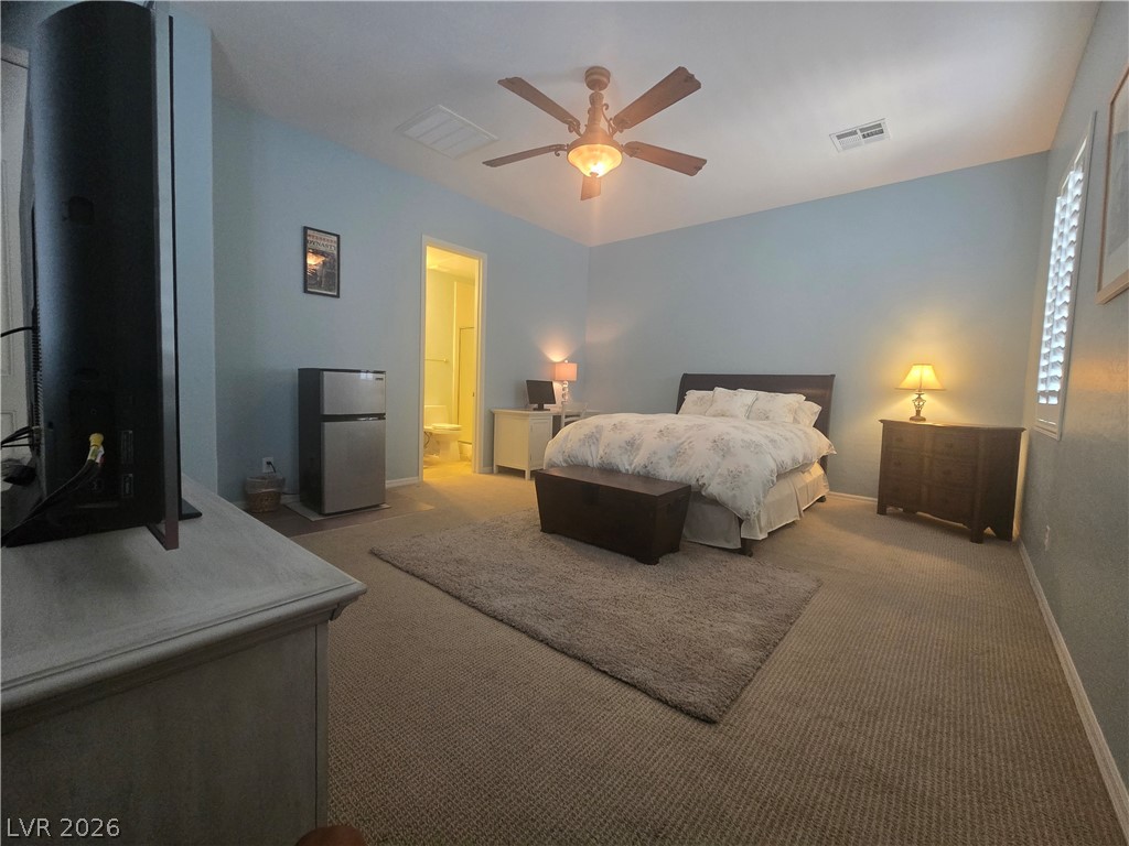 2567 Dirleton Place Henderson, NV 89044 - Photo 50 of 67 A well-lit bedroom features plush carpeting and a convenient ceiling fan.
