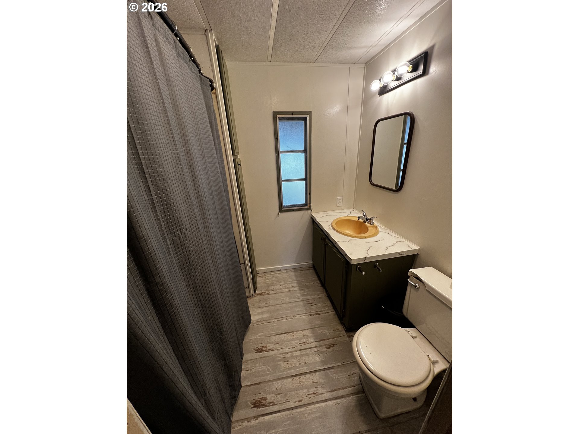355 North 8th Street Lakeside, OR 97449 - Photo 19 of 22 a bathroom with a toilet and a mirror