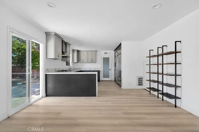 a view of kitchen with cabinets and wooden floor